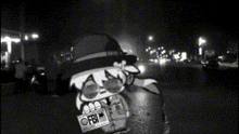 a black and white photo of a man with a fbi license plate
