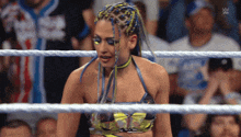 a woman in a wrestling ring with the letters w on the bottom
