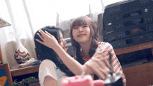 two girls are hugging each other in front of a stereo