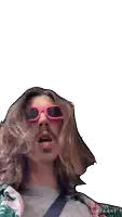a man with long hair wearing pink sunglasses with the word bazaar on the bottom right