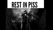 a black and white photo of a man in a suit and hat with the caption rest in piss