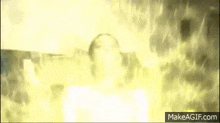 a person is standing in a room with a lot of flames coming out of them .