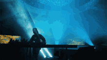 a man in a black shirt with the letter w on it is playing a dj set