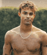 a shirtless man has a tattoo on his chest that says ii