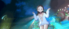 a girl in a bikini is standing on a stage with her arms outstretched in front of a blue background .