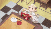 a girl is laying on a blanket using a laptop with a sticker that says ' a ' on it
