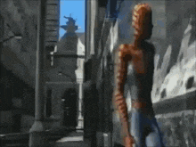 a person is standing in front of a wall that is on fire .