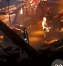 a group of people are playing instruments on a stage in a dark room .