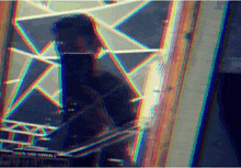 a blurry picture of a person taking a selfie with a rainbow colored background and the word cornridge in the corner