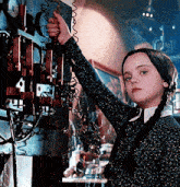 a girl in a plaid sweater is holding a telephone