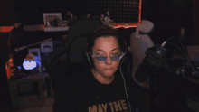 a woman wearing headphones and a may the force shirt