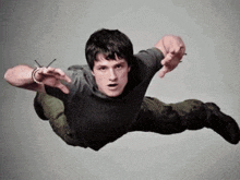 a man is flying through the air with his hands outstretched