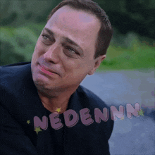 a man with a sad look on his face with the word nedenn on the bottom