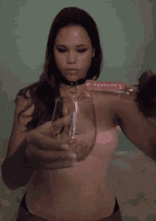 a woman is pouring a glass of wine from a bottle that says warriors