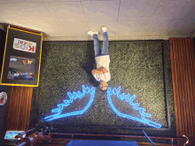 a man standing upside down in front of a kids meal sign