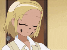 a girl with blonde hair and black spots on her face is standing in front of a door