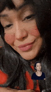 a close up of a woman 's face with a picture of another woman in the background