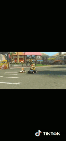 a video game is being played on a cell phone and a trophy is on the ground .