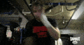 a man is wearing a tapout shirt and boxing gloves
