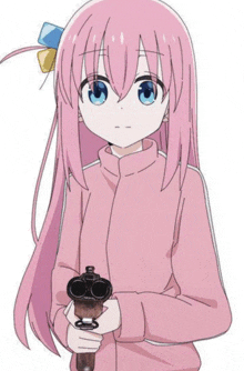 a girl with long pink hair is holding a gun in her hand .