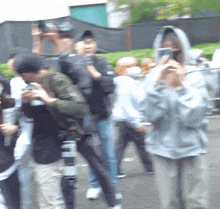 a blurry photo of a group of people with one wearing a hoodie