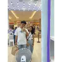 a man taking a picture of himself and a girl in front of a mirror