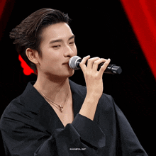 a man singing into a microphone with the words khunpol gif written on the bottom
