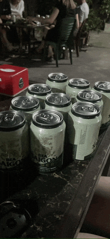 a bunch of cans of saigon beer are on a table