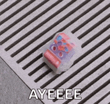 a toy is sitting on top of a drain on a concrete surface .