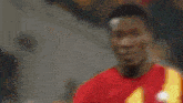 a man in a red shirt with the number 10 on it