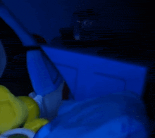 a person is laying in a bed with a blue blanket