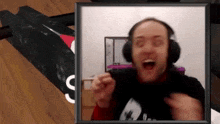 a man wearing headphones and a shirt that says ' supreme ' on it