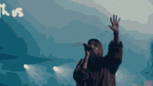 a woman singing into a microphone in front of a sign that says thursday