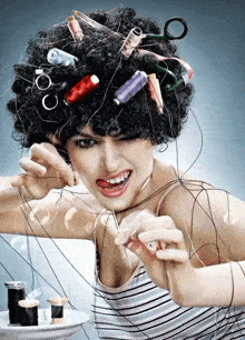 a woman with spools of thread in her hair is sewing