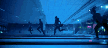 a group of people are running down a bowling alley with a sign that says ' bowling ' on it