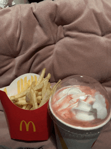 a mcdonald 's box of french fries and a pink drink