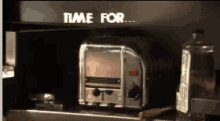 a toaster sits on a counter under a sign that says " time for "