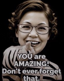 a woman wearing glasses is pointing at the camera with the words you are amazing don t ever forget that