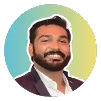 a man with a beard is smiling in front of a blue and yellow background