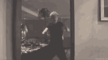 a black and white photo of a man dancing in front of a mirror with the word prince in the corner