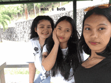 three girls are posing for a picture with the words miss u both behind them