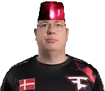 a man wearing glasses and a red hat is wearing a black shirt with the letter f on it .