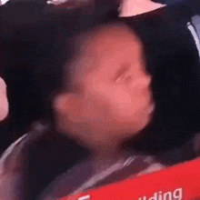 a little girl is making a funny face while sitting in a car .