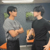 two men standing next to each other with one wearing a grey shirt that says ' yssd ' on it