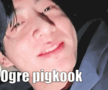 a close up of a person 's face with the words `` ogre pigkook '' written on it .