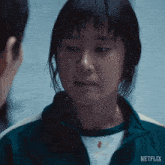 a close up of a woman 's face with netflix written on the bottom