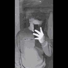 a man taking a picture of himself in the mirror