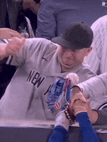 a man wearing a new york jersey shakes hands with a woman