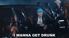 a man in a suit and tie is standing next to another man with the words i wanna get drunk on the bottom