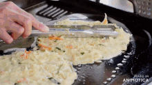 a person is cooking food in a pan that says made in animotica on the bottom